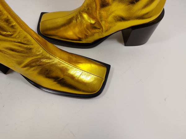 Golden boots on black heel