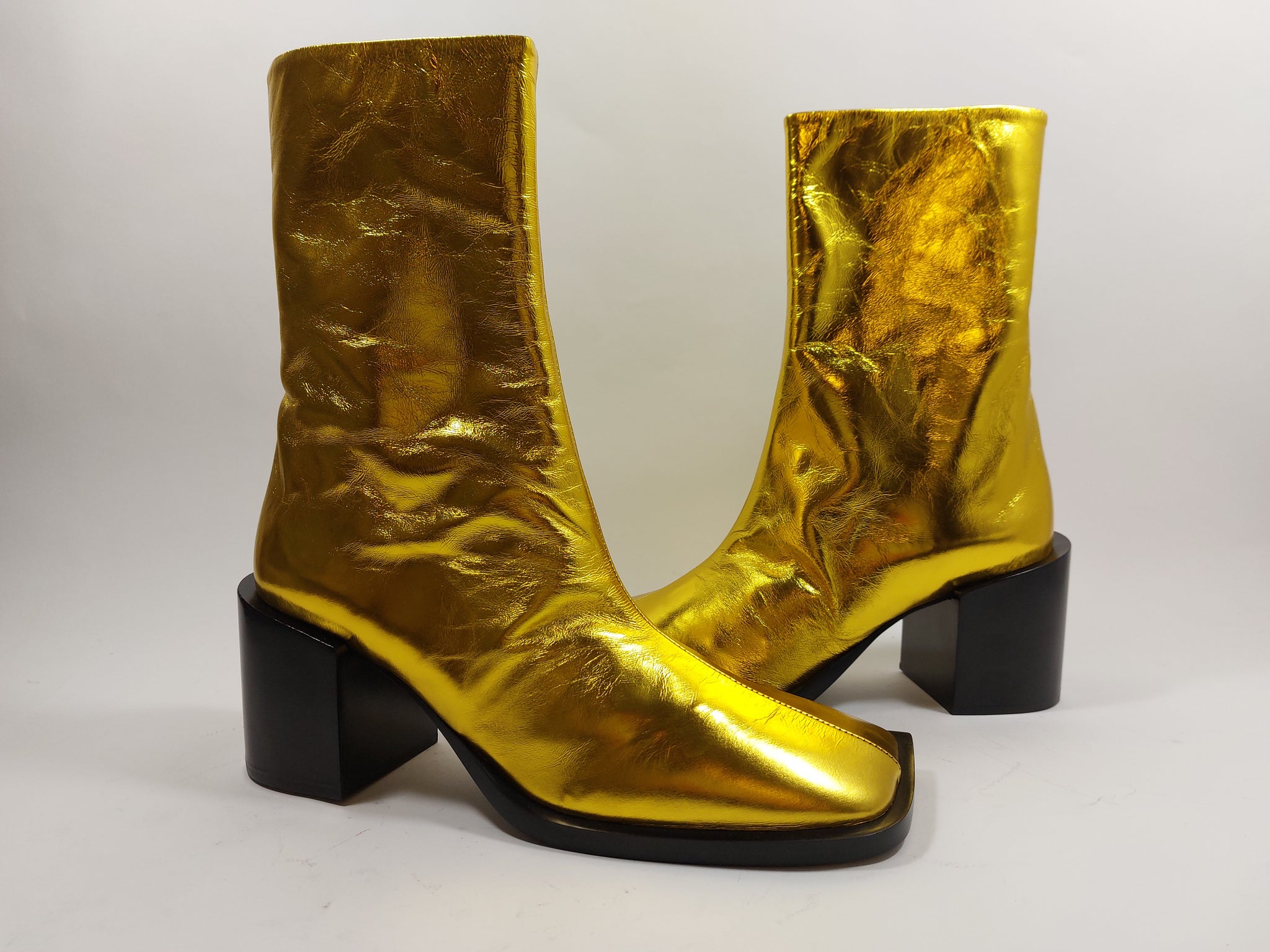Golden boots on black heel